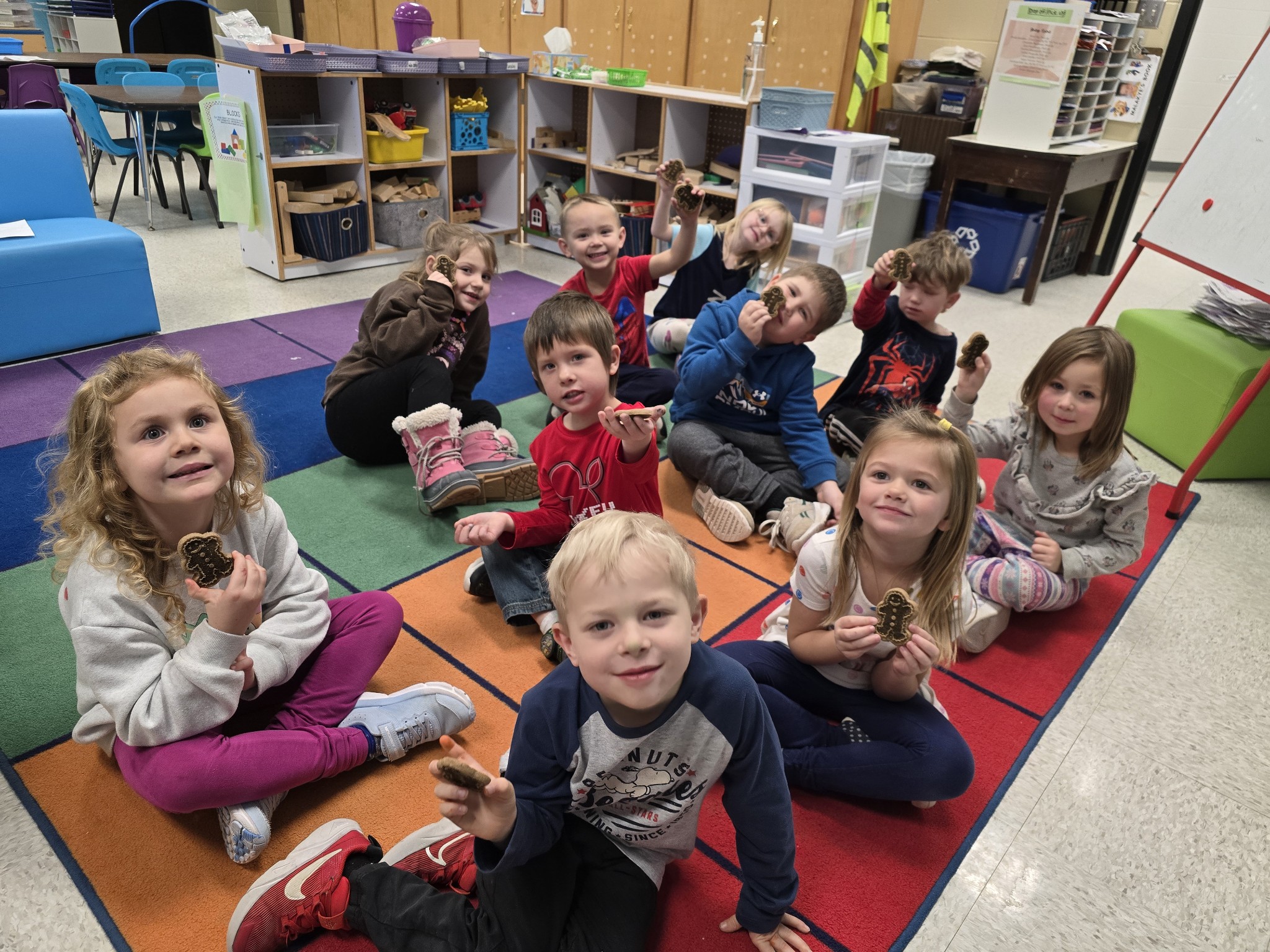 Elementary Students holding gingerbread cookies