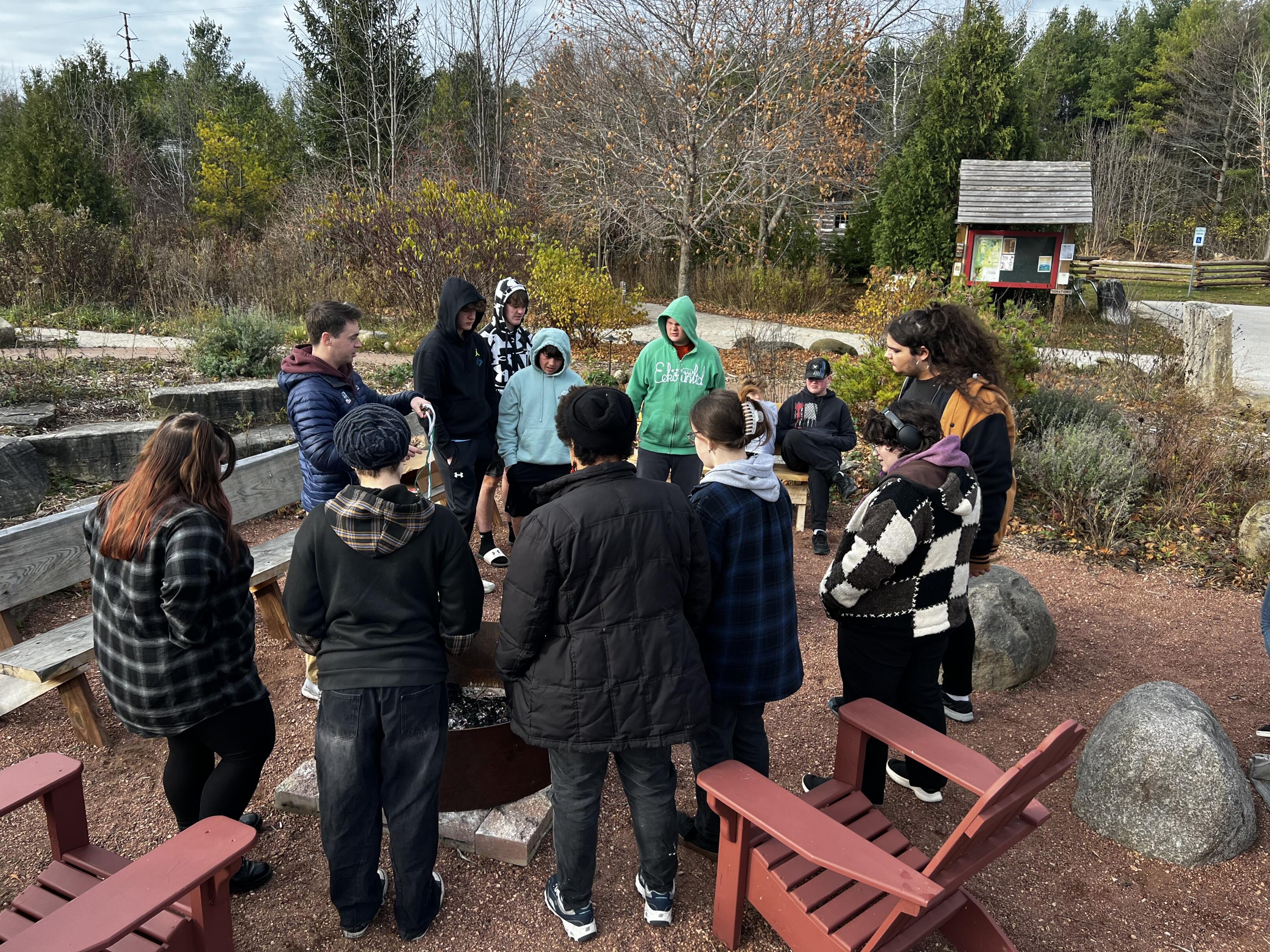 Students standing around a firepit
